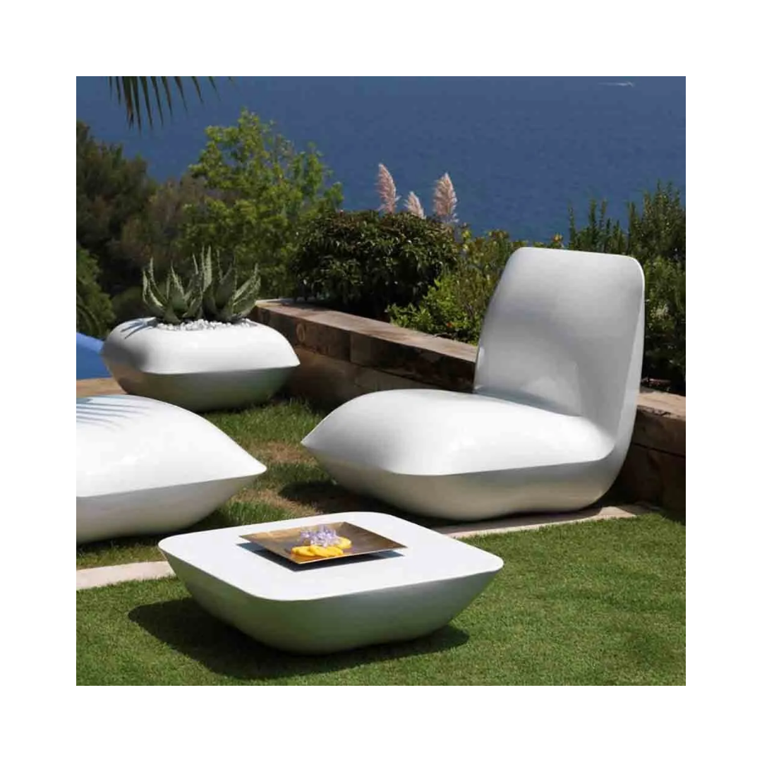 Vondom Pillow white lounge chair, ottoman, planter, and coffee table set on a garden terrace by the sea